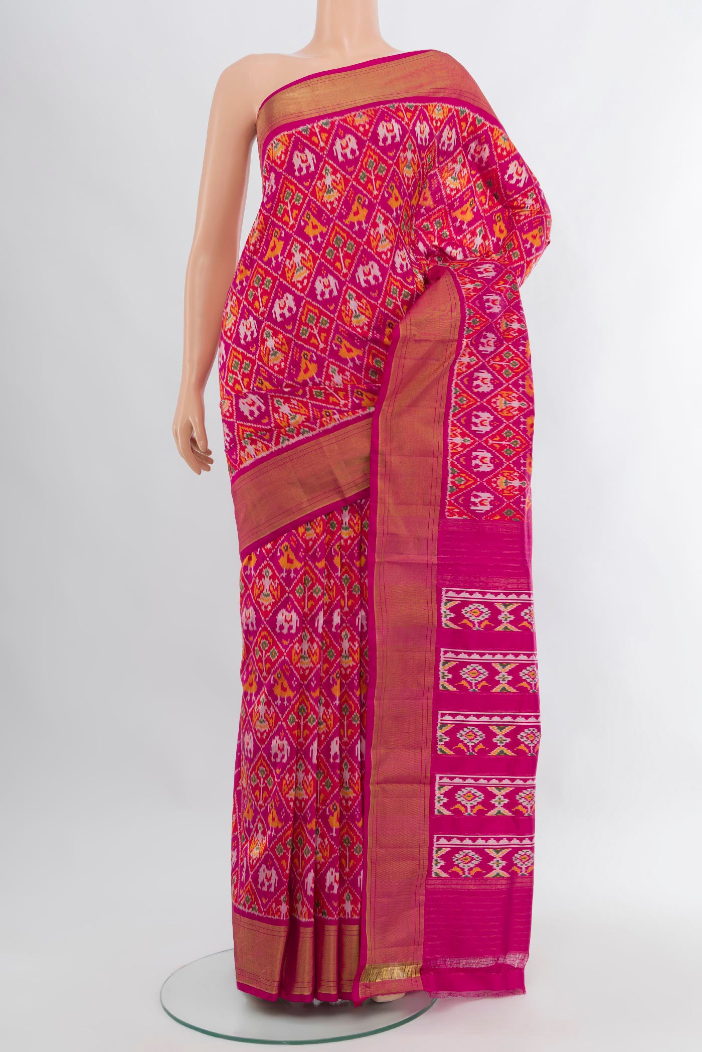 Pink Pochampally Silk Saree with Ikat design on the body and Zari Border.  displayed on a mannequin