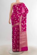 Pure Silk Magenta Banarasi Raw Saree with Zari Butta on the body and Silk Border.  displayed on a mannequin