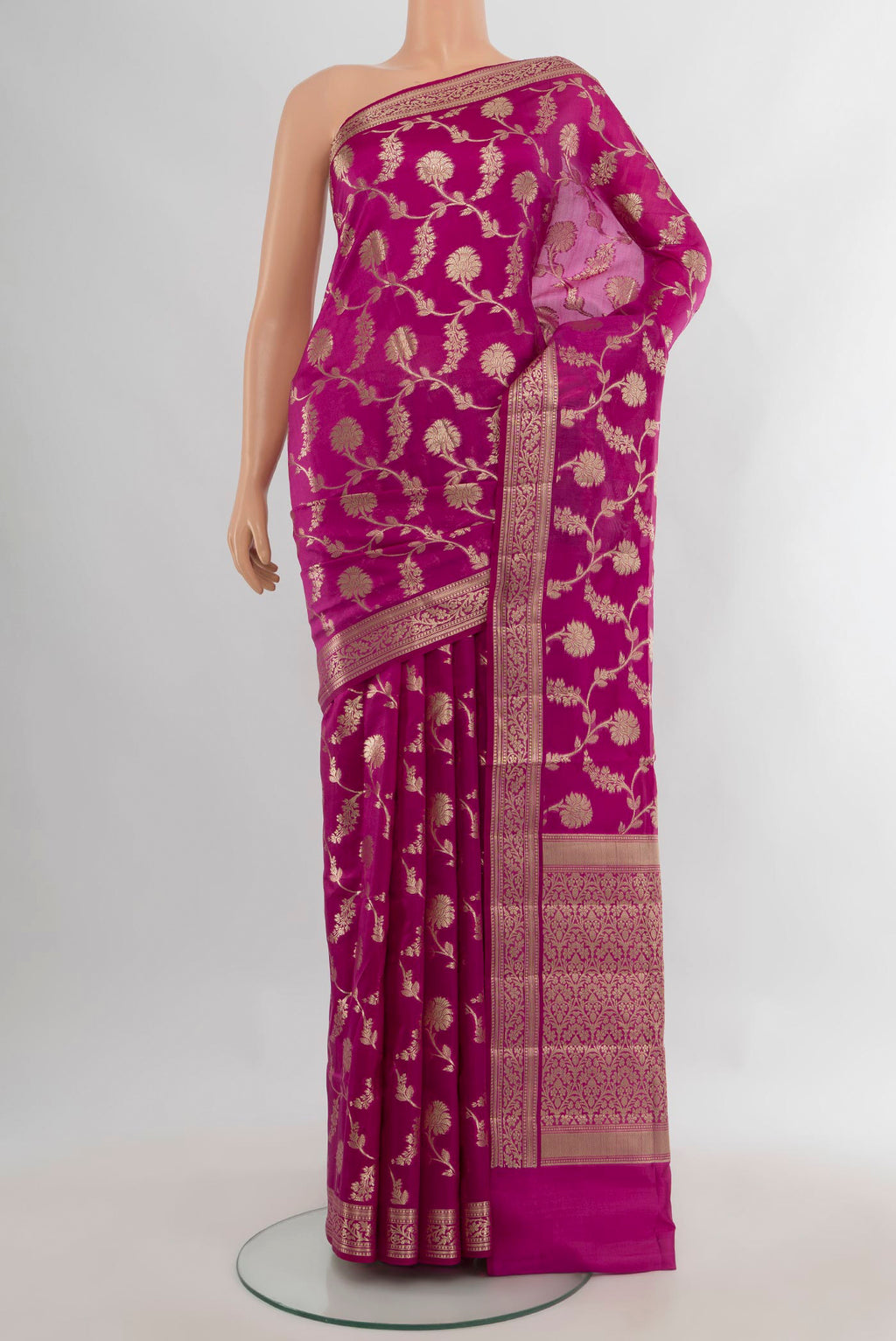 Pure Silk Magenta Banarasi Raw Saree with Zari Butta on the body and Zari Border.  displayed on a mannequin