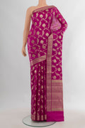 Pure Silk Magenta Banarasi Raw Saree with Zari Butta on the body and Zari Border.  displayed on a mannequin