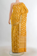 Pure Silk Mustard Banarasi Raw Saree with Zari Butta on the body and Silk Border.  displayed on a mannequin