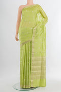 Pista Green Banarasi Raw Silk Saree with Zari Butta on the body and Silk Border.  displayed on a mannequin