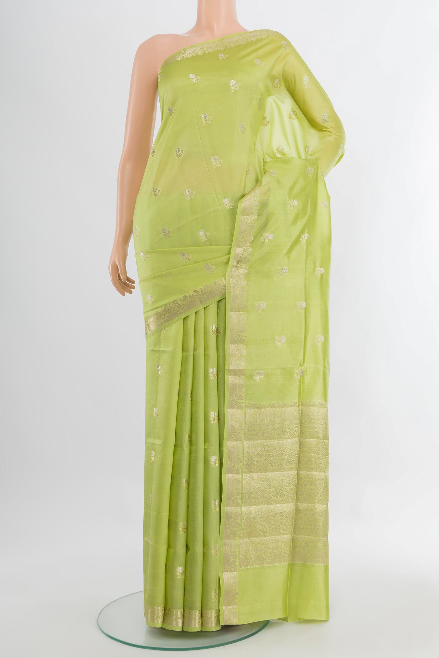 Pista Green Banarasi Raw Silk Saree with Zari Butta on the body and Silk Border.  displayed on a mannequin