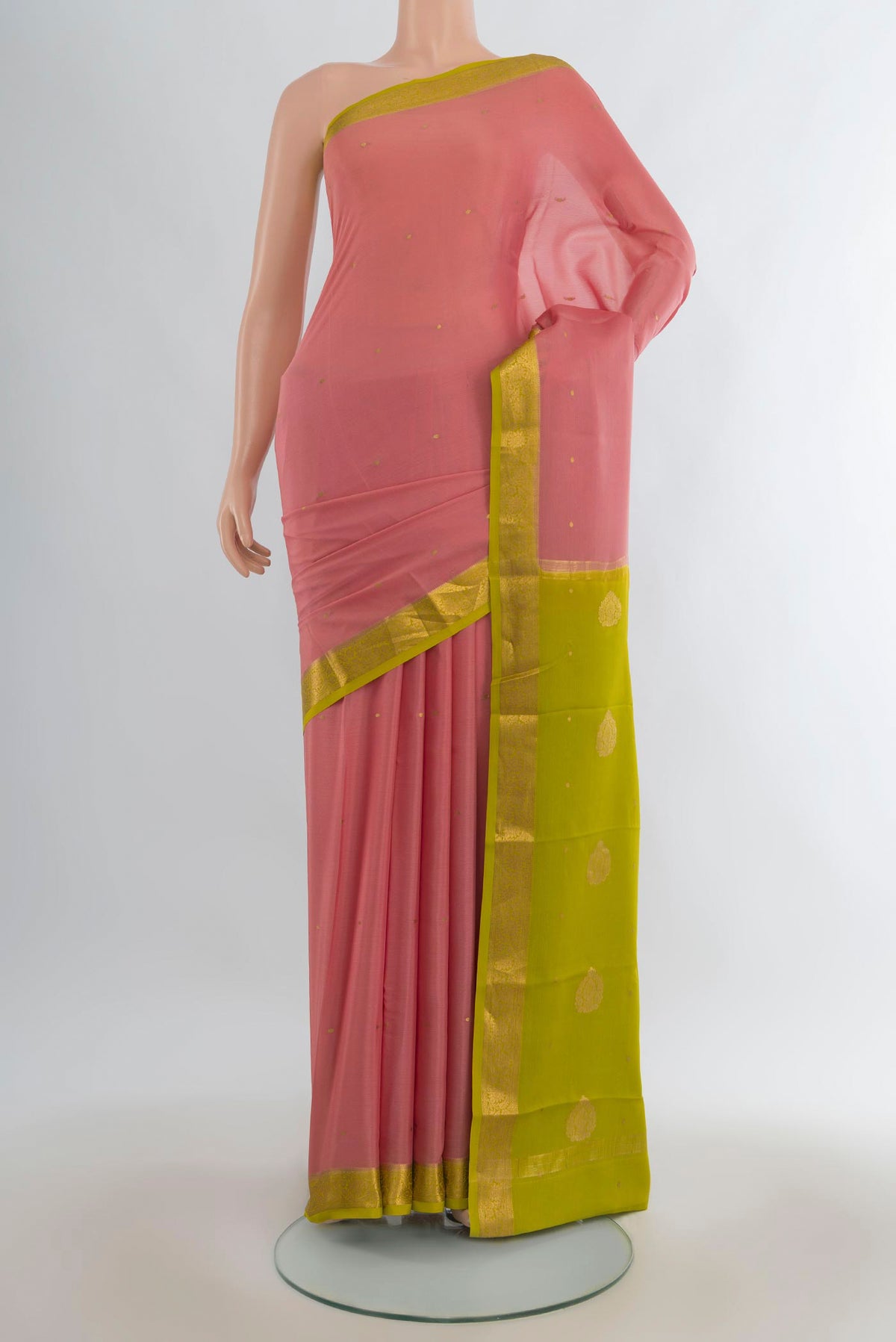 Peach Mysore Crepe Saree with Zari Butta on the body and Zari Border.  displayed on a mannequin