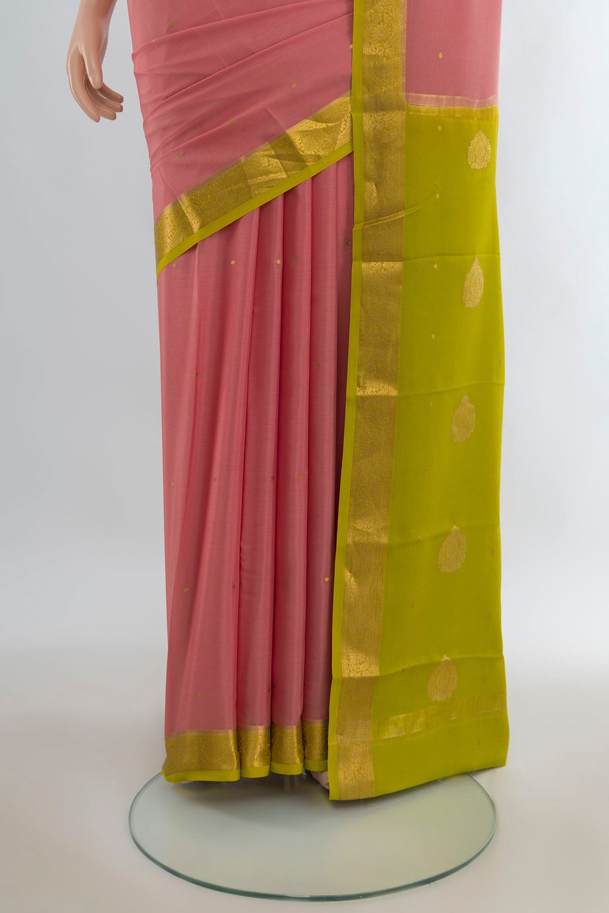 Pleats and pallu of Peach Mysore Crepe Saree with Zari Butta on the body and Zari Border. 