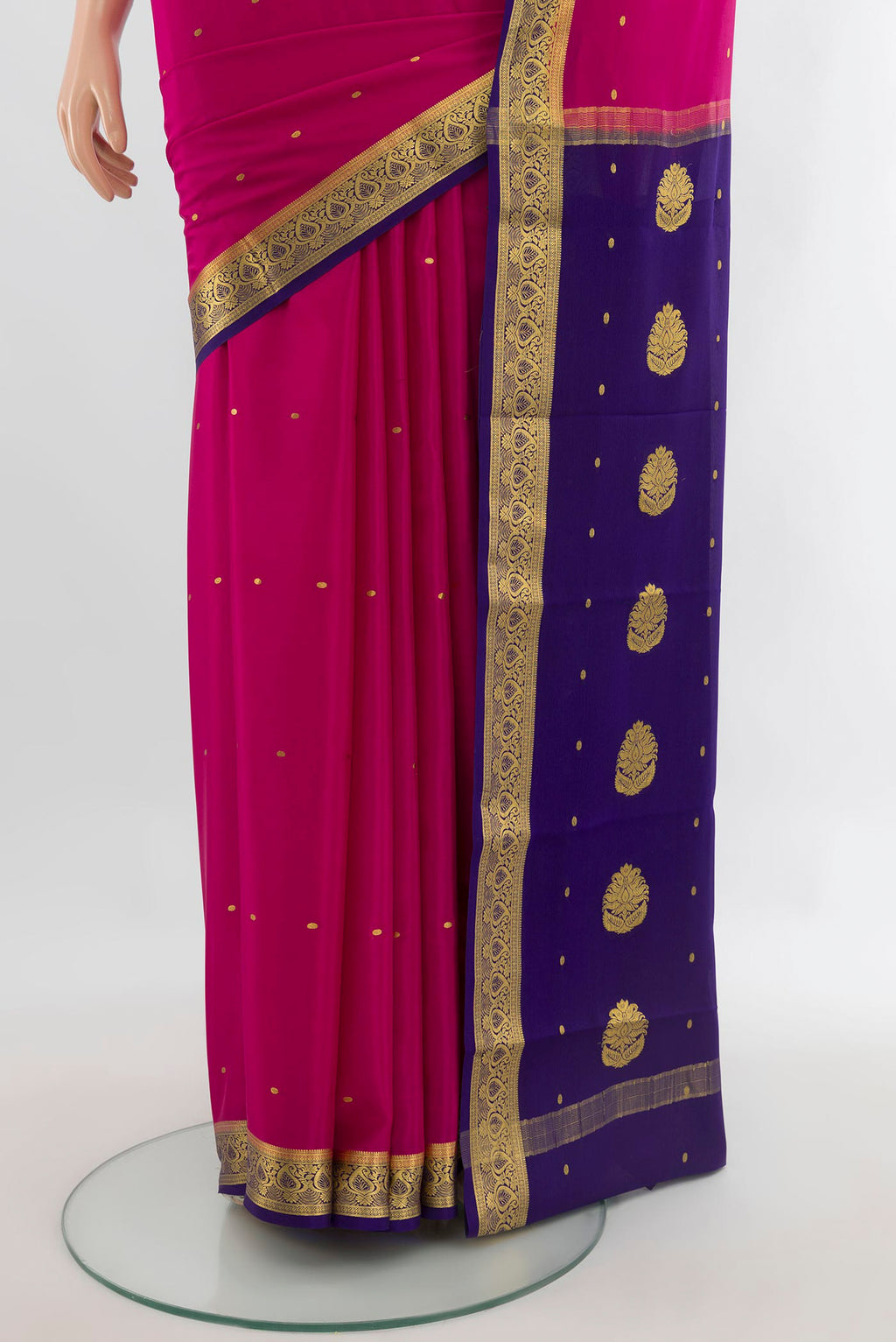 Pleats and pallu of Rani Pink Mysore Crepe Saree with Zari Butta on the body and Zari Border. 