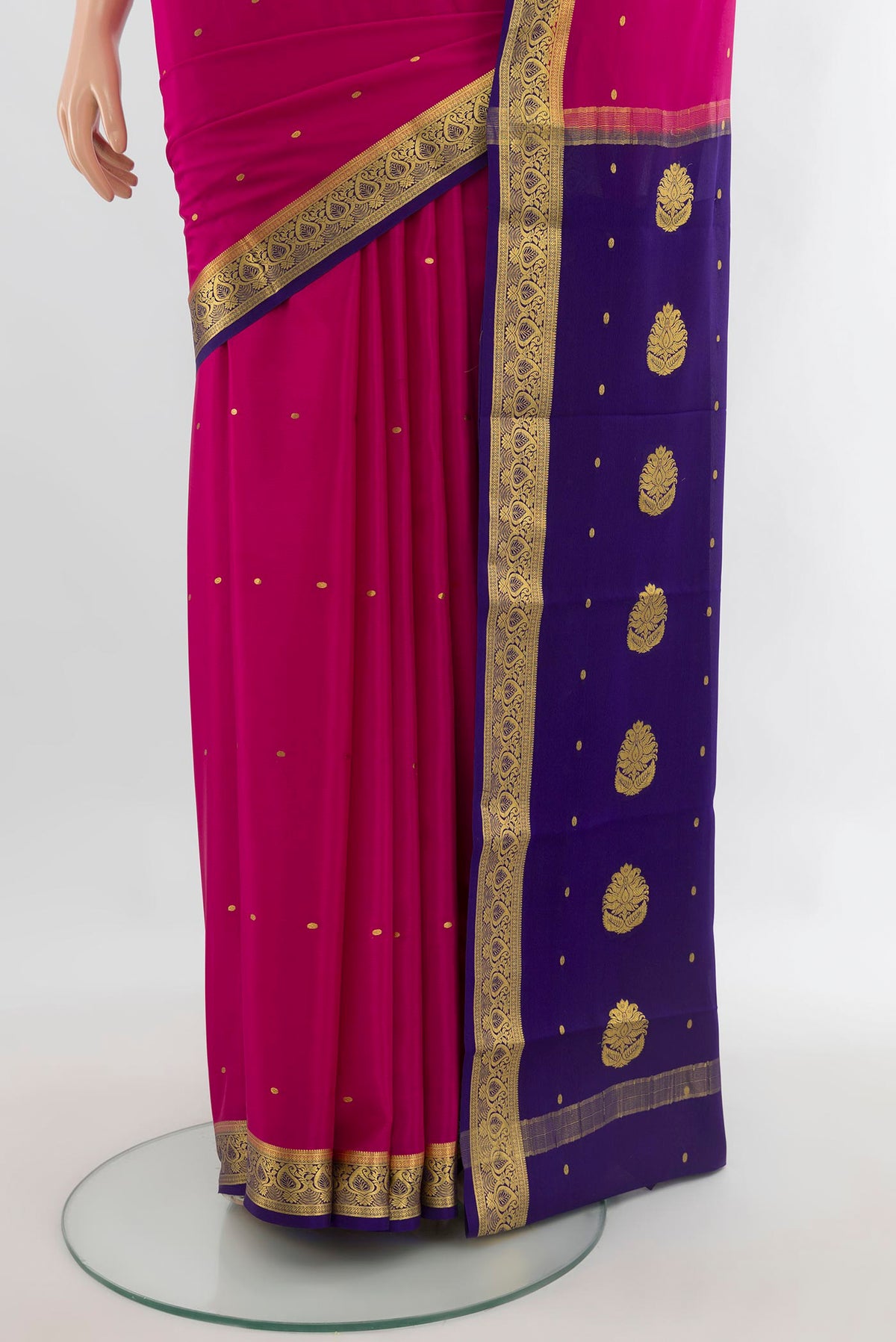 Pleats and pallu of Rani Pink Mysore Crepe Saree with Zari Butta on the body and Zari Border. 