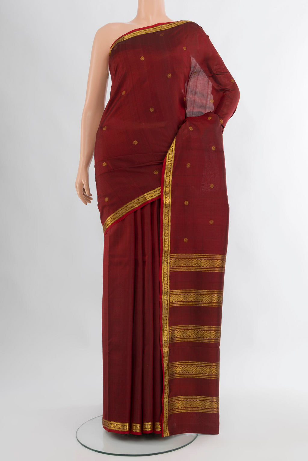 Maroon Kanchipuram Silk Saree with Zari Butta on the body and Zari Border.  displayed on a mannequin