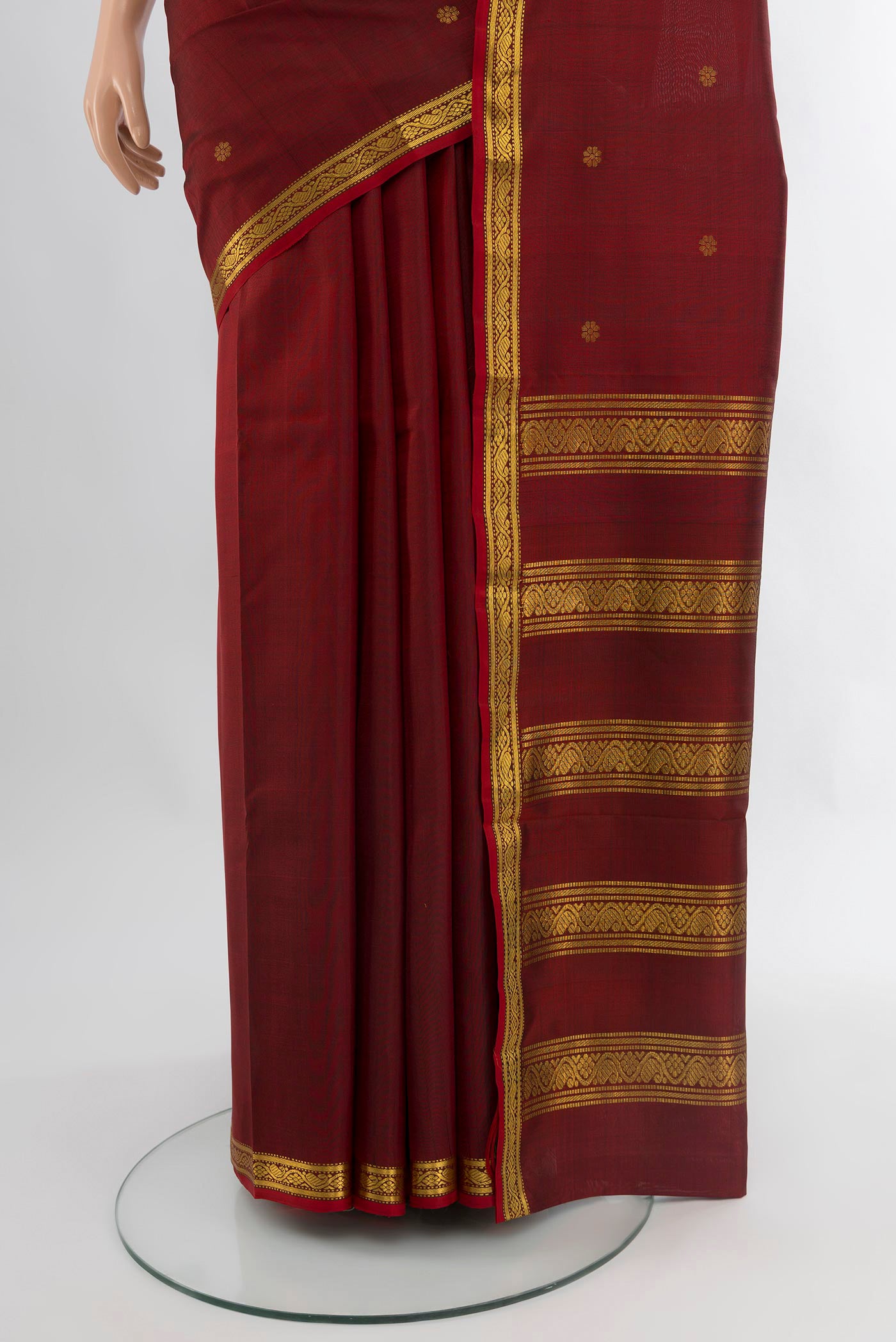Pleats and pallu of Maroon Kanchipuram Silk Saree with Zari Butta on the body and Zari Border. 