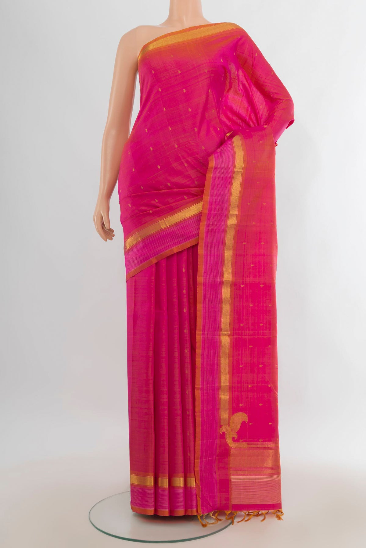 Pure Silk Pure Zari Peach Kanchipuram Saree with Zari Butta on the body and Silk Border.  displayed on a mannequin