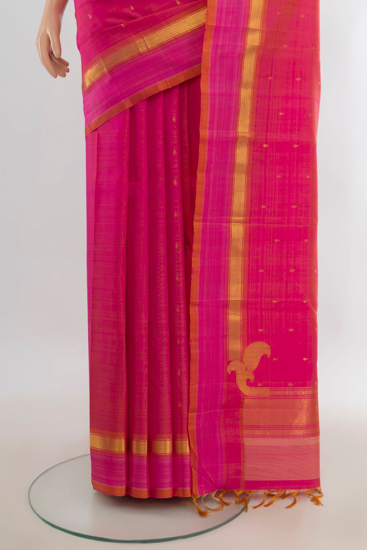 Pleats and pallu of Pure Silk Pure Zari Peach Kanchipuram Saree with Zari Butta on the body and Silk Border. 