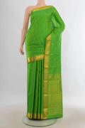 Pure Silk Parrot Green Kanjivaram Saree with Zari Butta on the body and Zari Border.  displayed on a mannequin