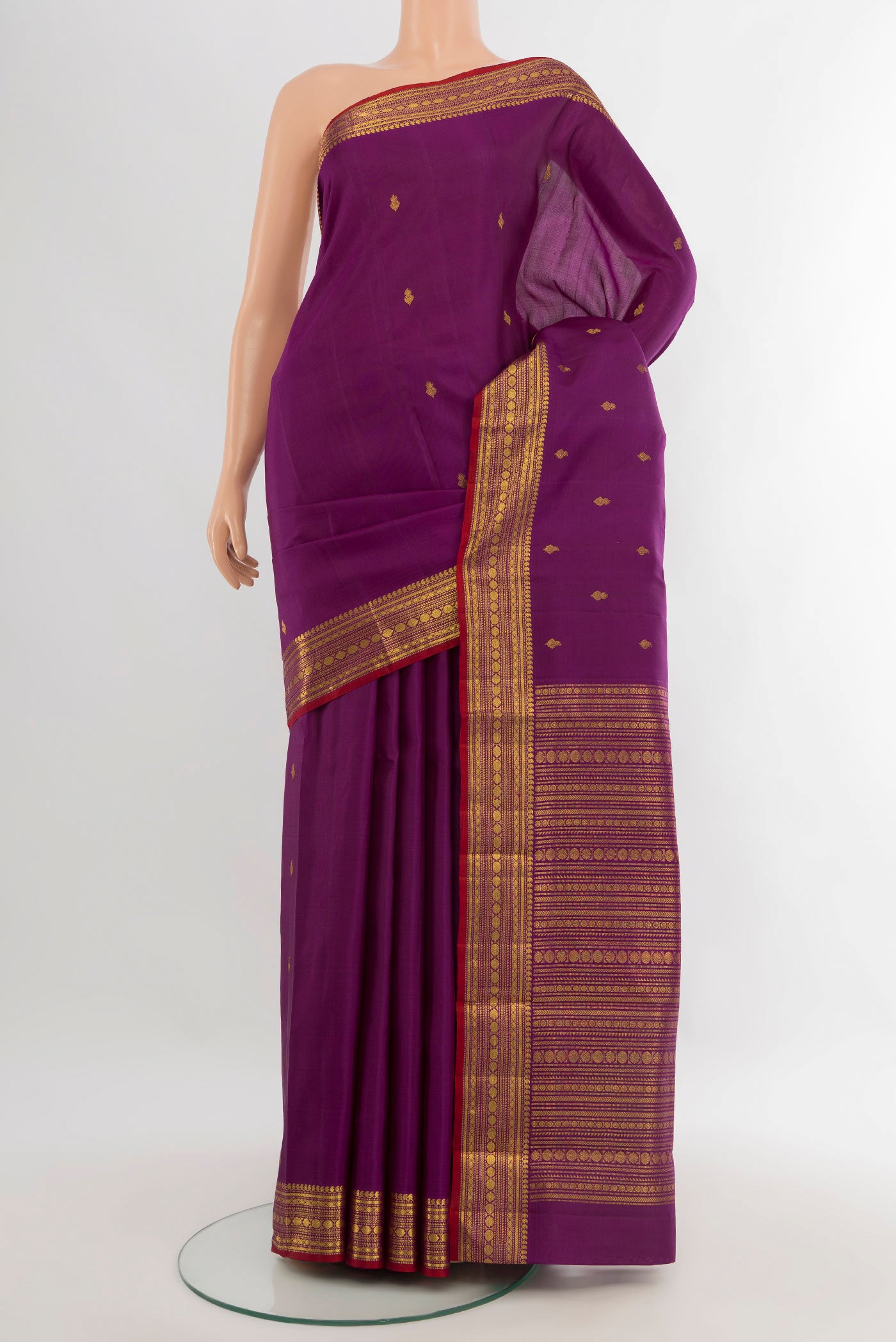Purple Kanjivaram Silk Saree with Zari Butta on the body and Zari Border.  displayed on a mannequin