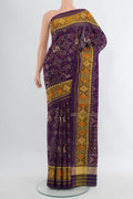 Violet Rajkot Patola Silk Saree with Pure Ikat on the body and Ikat Border.  displayed on a mannequin