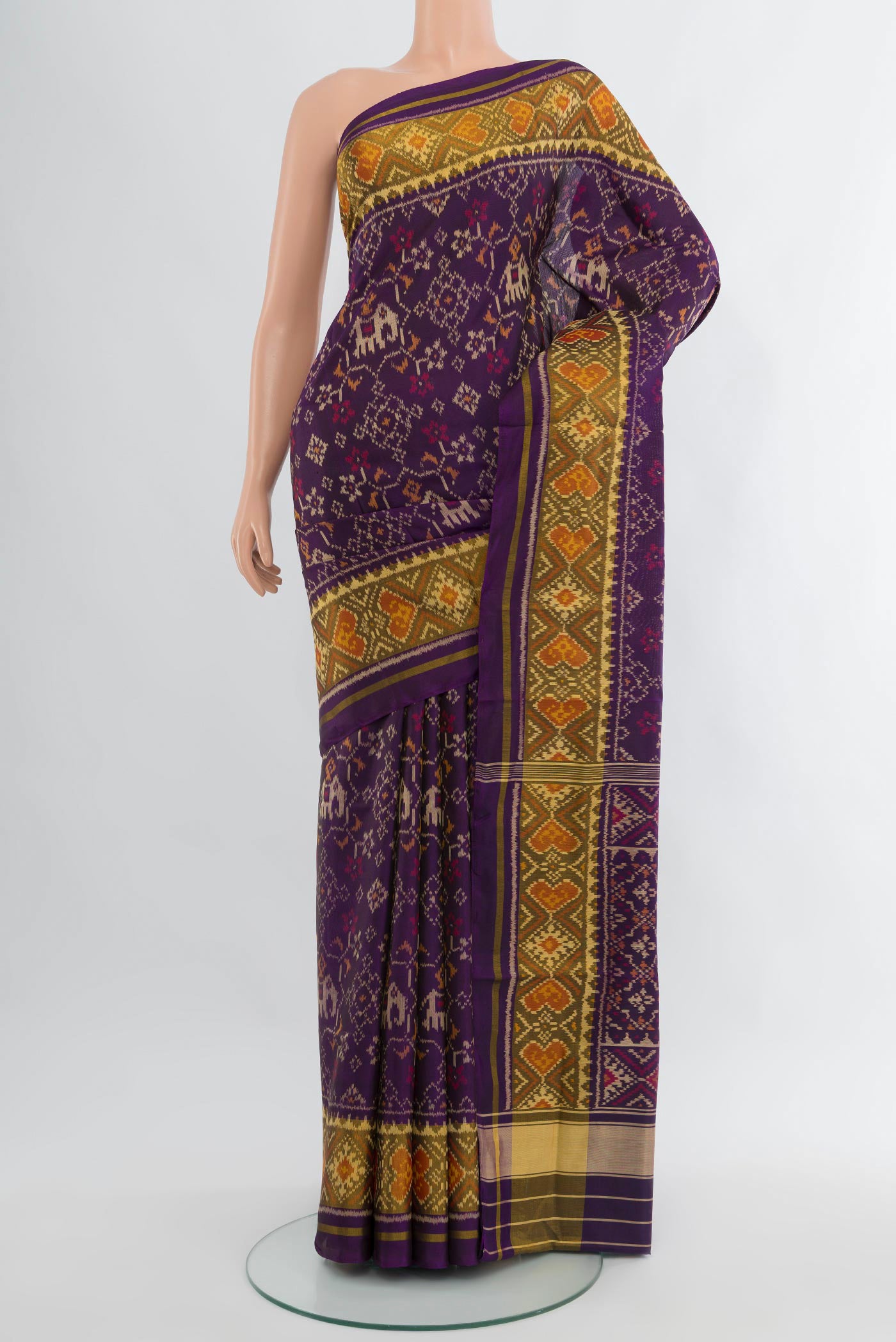 Violet Rajkot Patola Silk Saree with Pure Ikat on the body and Ikat Border.  displayed on a mannequin