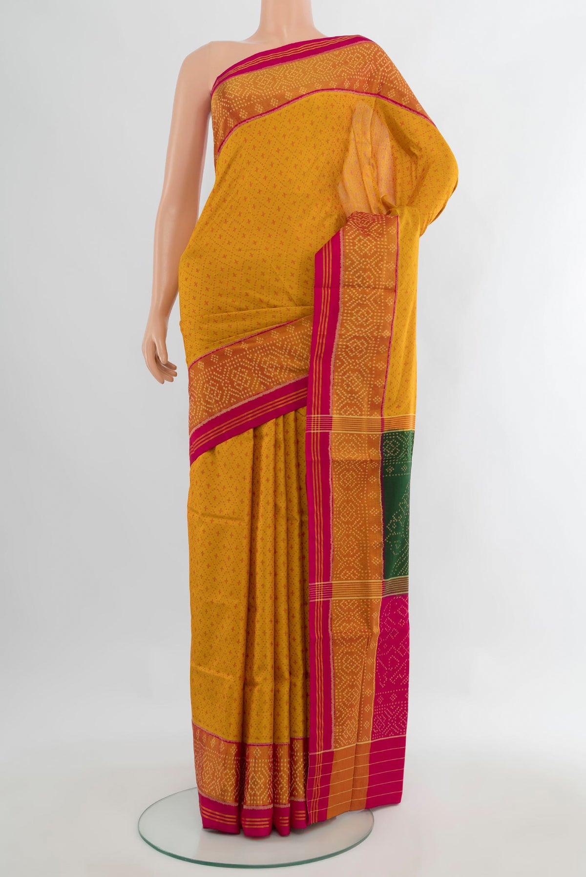 Pure Silk Yellow Rajkot Patola Saree with Pure Ikat on the body and Ikat Border.  displayed on a mannequin