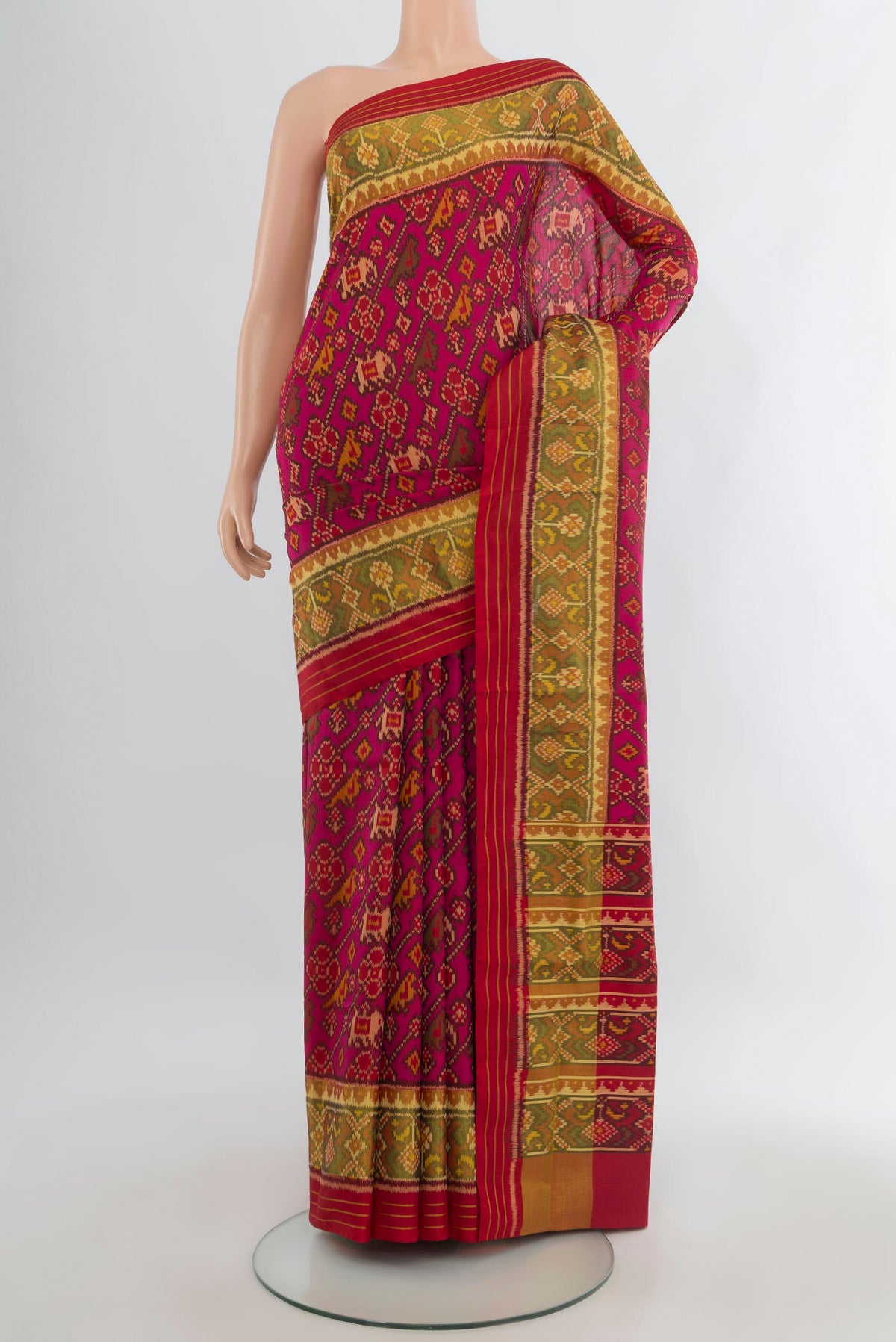 Pure Silk Dark Pink Rajkot Patola Saree with Pure Ikat on the body and Ikat Border.  displayed on a mannequin