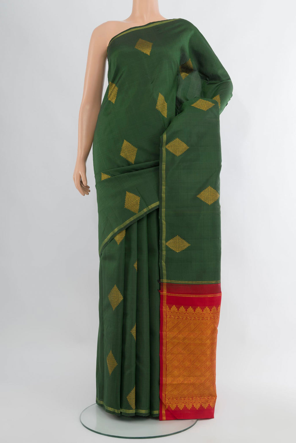 Bottle Green Kanchipuram Silk Saree with Zari Butta on the body and Zari Border.  displayed on a mannequin