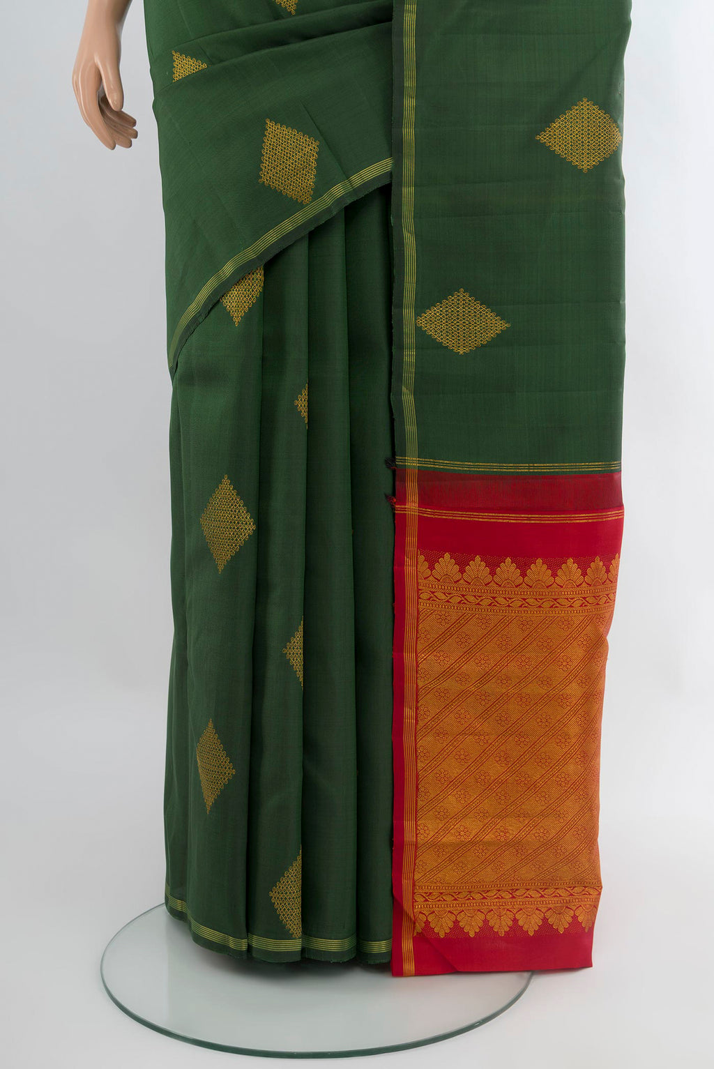 Pleats and pallu of Bottle Green Kanchipuram Silk Saree with Zari Butta on the body and Zari Border. 