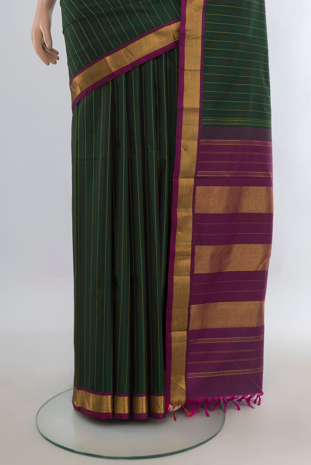 Pleats and pallu of Pure Silk Bottle Green Kanchipuram Saree with Stripes on the body and Zari Border. 