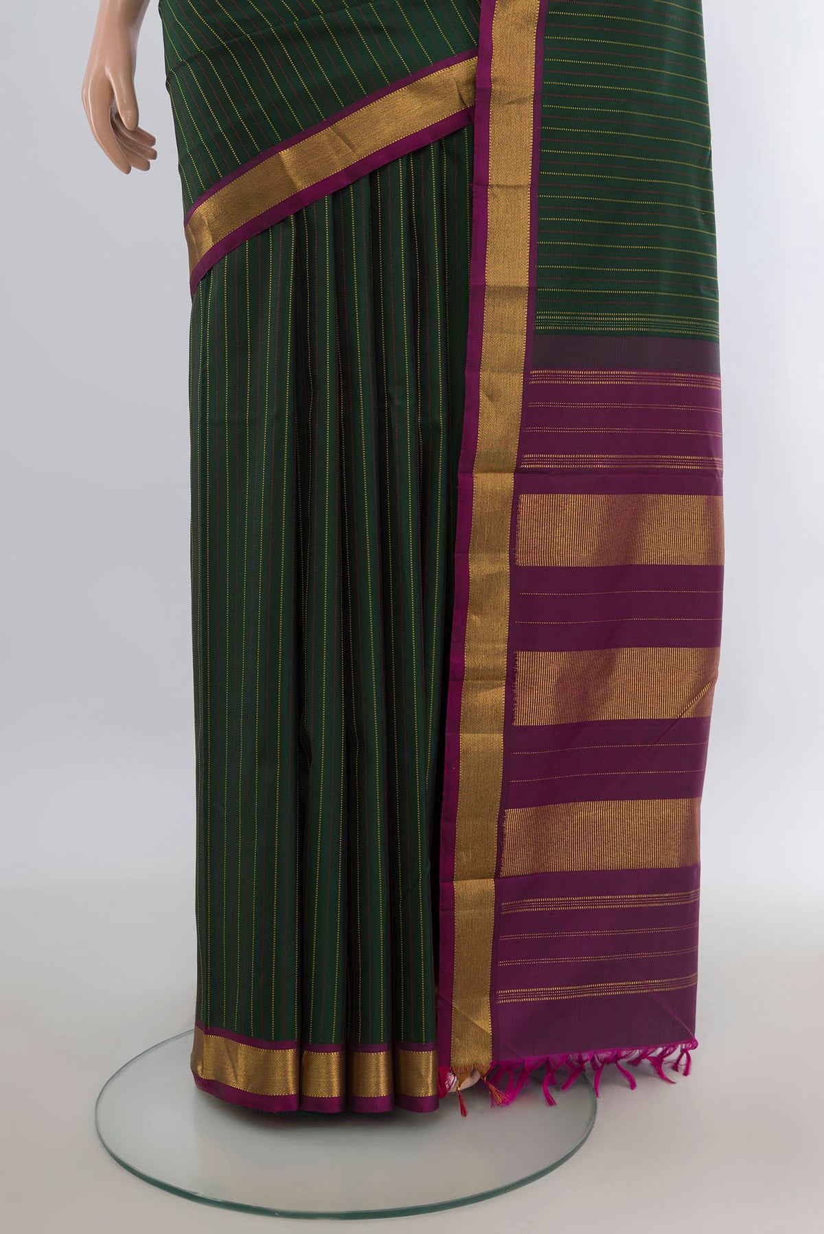Pleats and pallu of Pure Silk Bottle Green Kanchipuram Saree with Stripes on the body and Zari Border. 