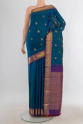 Pure Silk Pure Zari Peacock Blue Kanjivaram Saree with Zari Butta on the body and Silk Border.  displayed on a mannequin