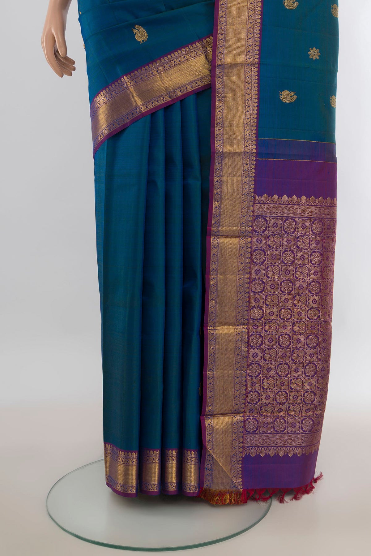 Pleats and pallu of Pure Silk Pure Zari Peacock Blue Kanjivaram Saree with Zari Butta on the body and Silk Border. 