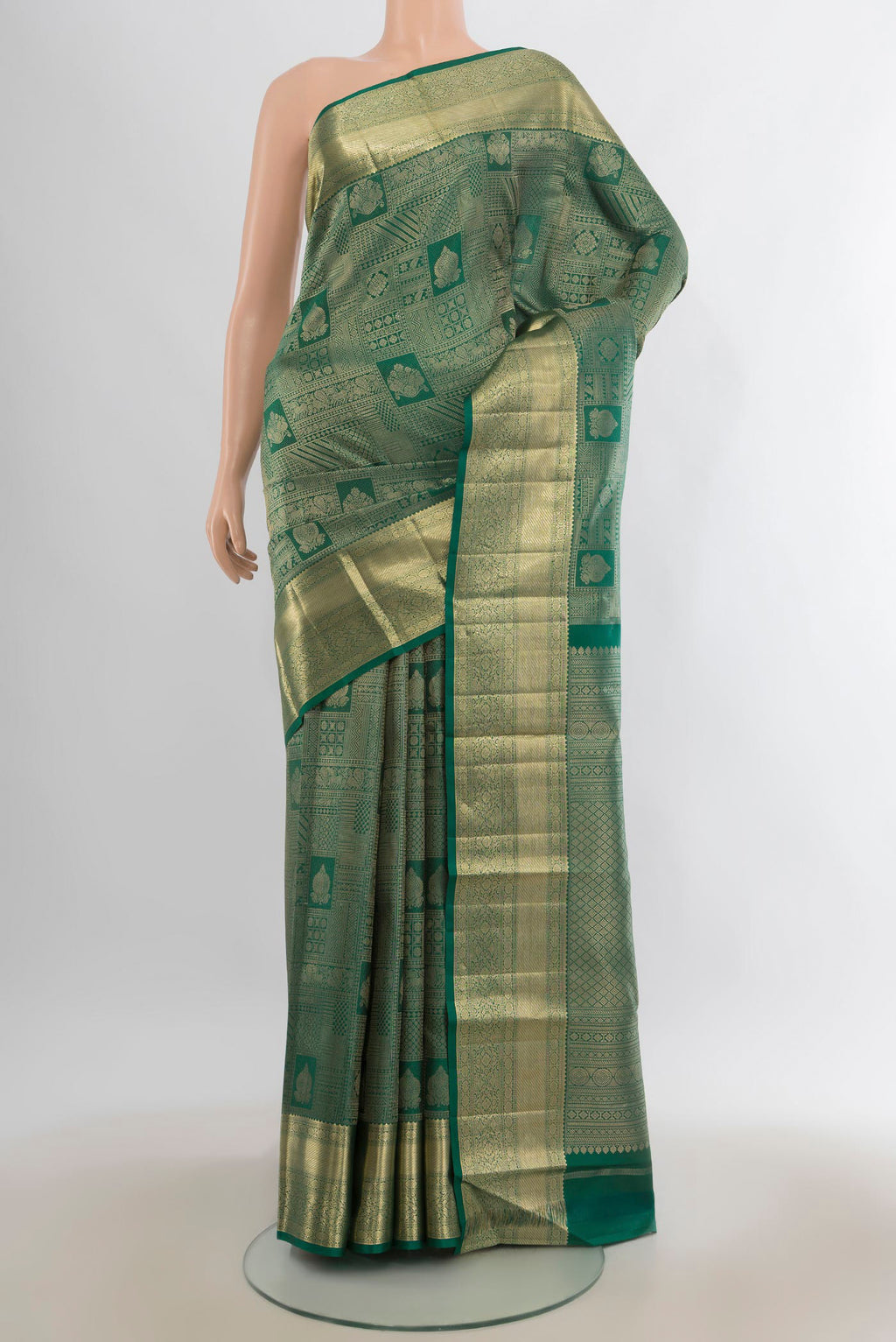 Pure Silk Green Kanjivaram Saree with Zari Brocade on the body and Zari Border.  displayed on a mannequin