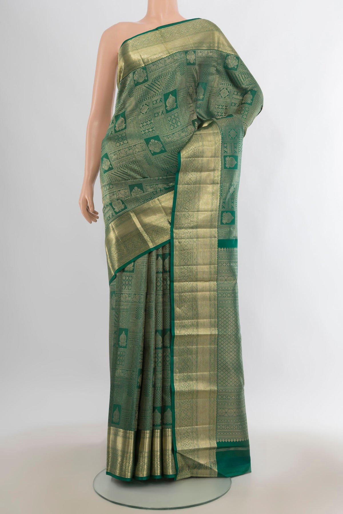Pure Silk Green Kanjivaram Saree with Zari Brocade on the body and Zari Border.  displayed on a mannequin