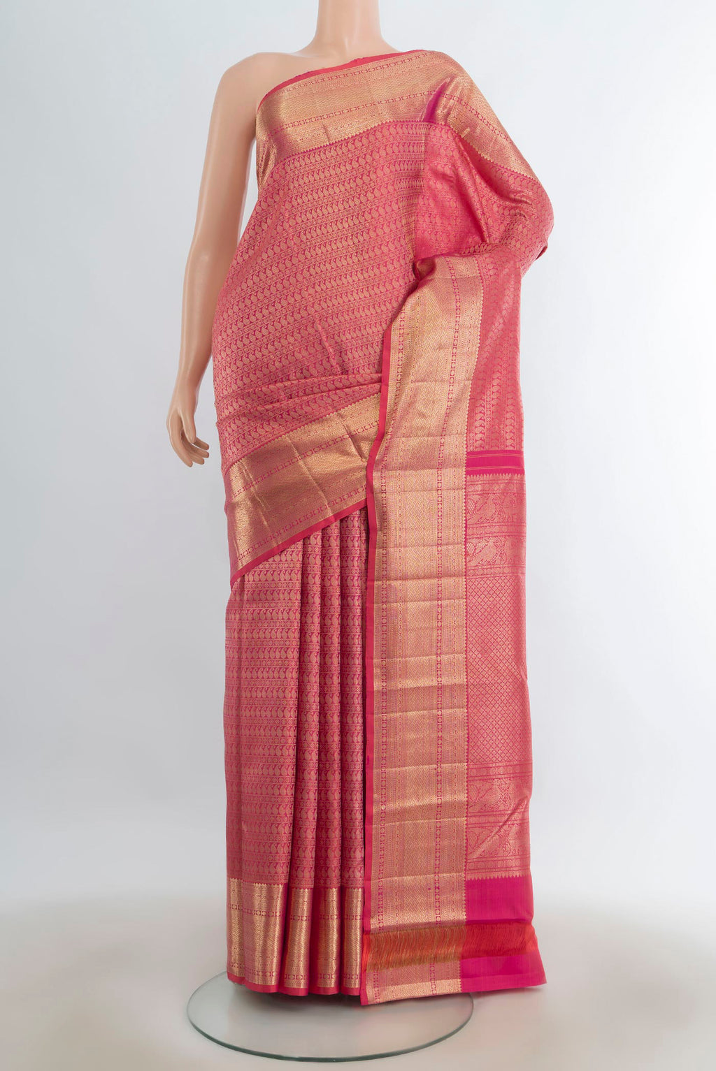 Pure Silk Rose Gold Kanchipuram Saree with Zari Butta on the body and Silk Border.  displayed on a mannequin