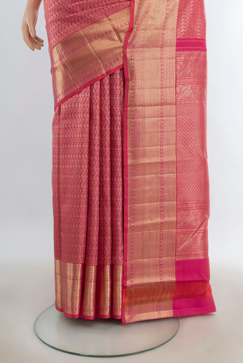 Pleats and pallu of Pure Silk Rose Gold Kanchipuram Saree with Zari Butta on the body and Silk Border. 