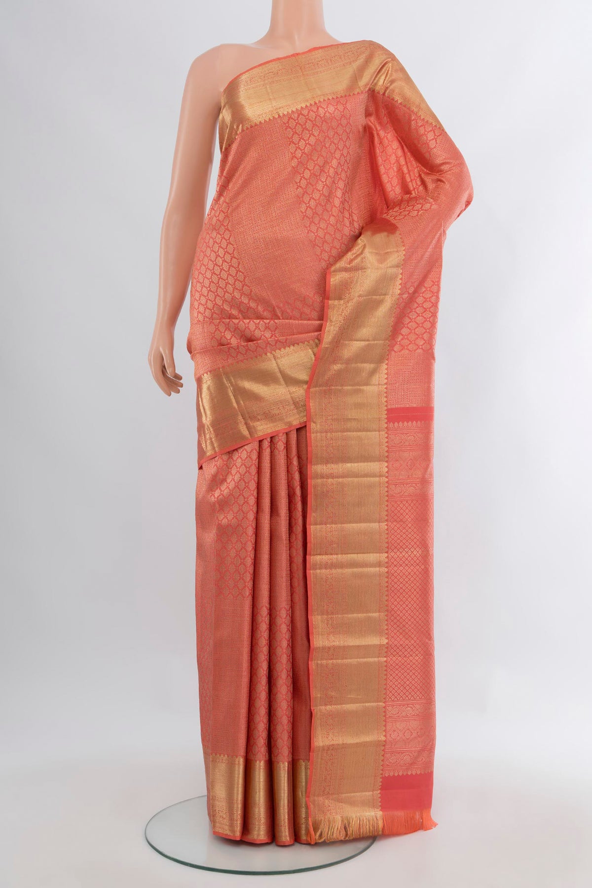 Coral Kanchipuram Silk Saree with Zari Brocade on the body and Zari Border.  displayed on a mannequin