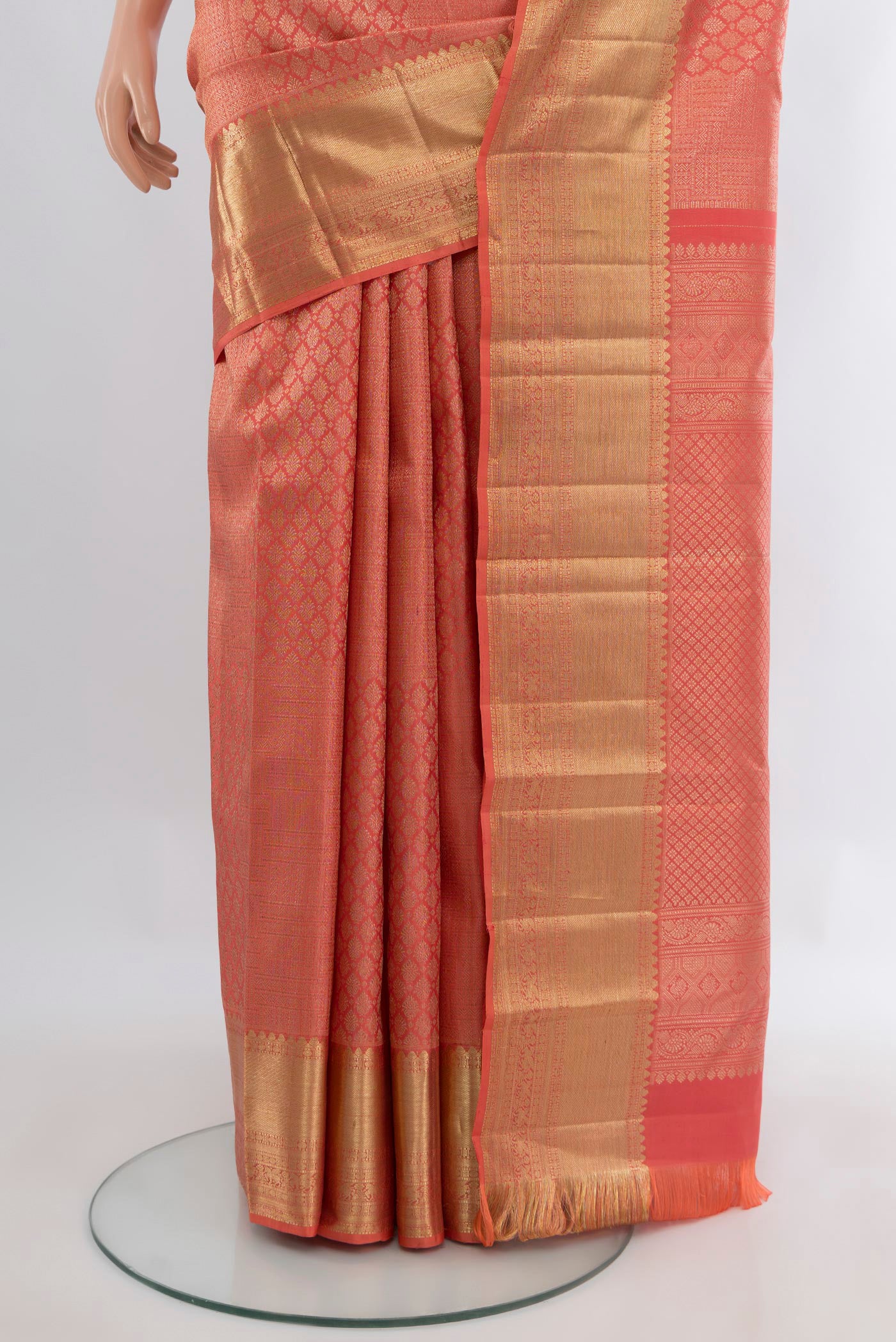 Pleats and pallu of Coral Kanchipuram Silk Saree with Zari Brocade on the body and Zari Border. 