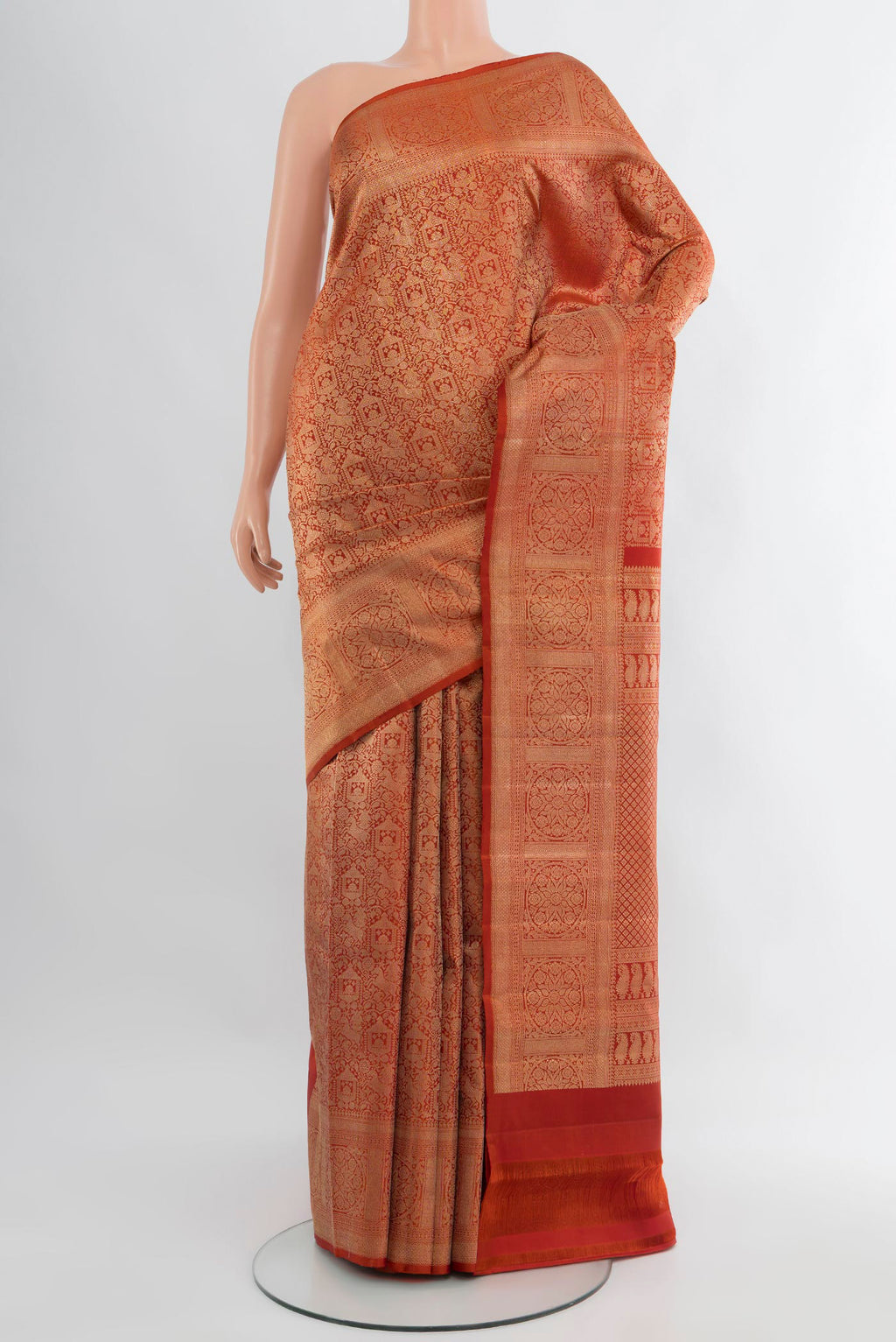 Rust Kanchipuram Silk Saree with Zari Brocade on the body and Zari Border.  displayed on a mannequin