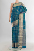 Pure Silk Peacock Blue Kanchipuram Saree with Checked design on the body and Zari Border.  displayed on a mannequin
