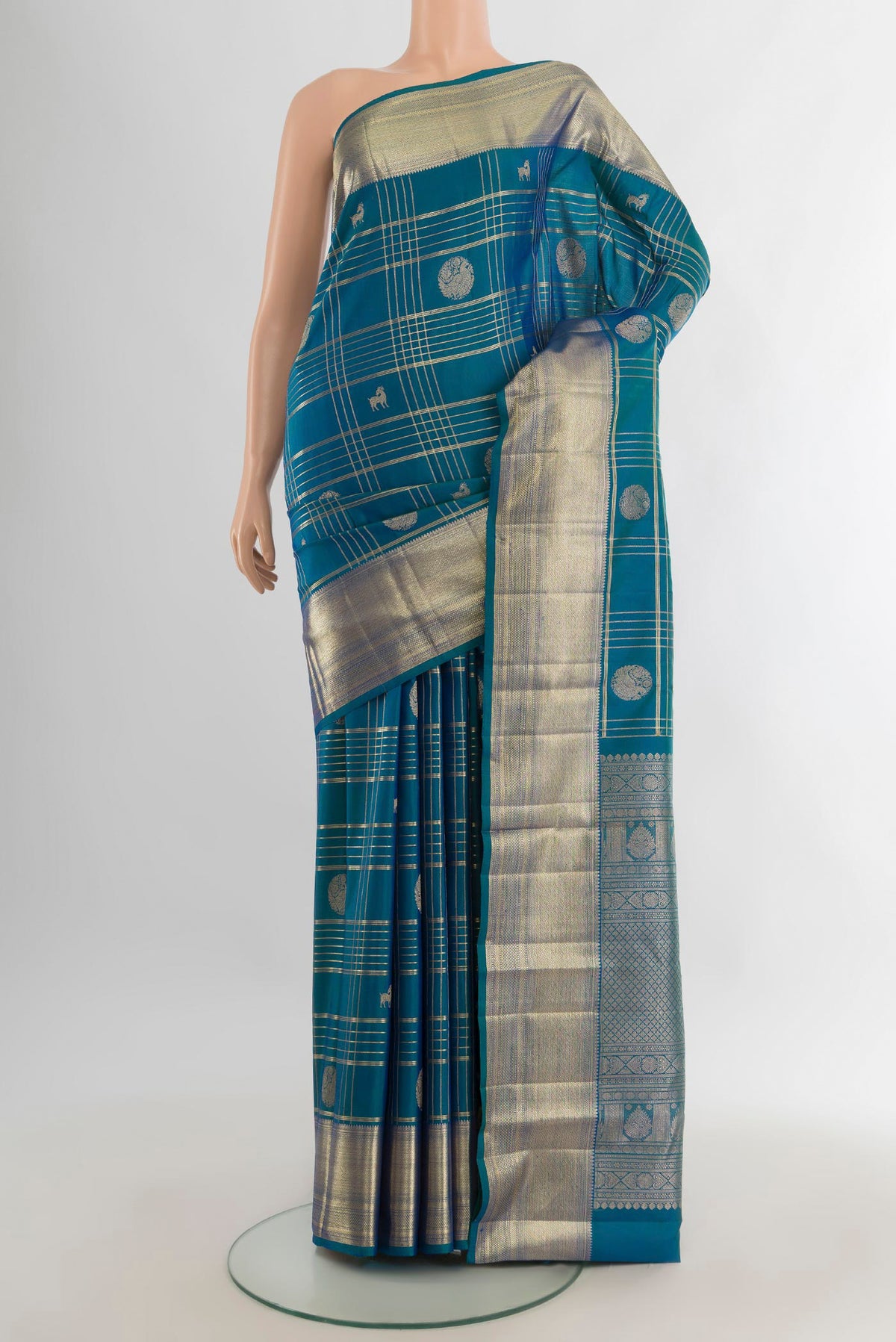 Pure Silk Peacock Blue Kanchipuram Saree with Checked design on the body and Zari Border.  displayed on a mannequin