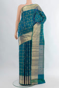Peacock Blue Kanchipuram Silk Saree with Checked design on the body and Zari Border.  displayed on a mannequin