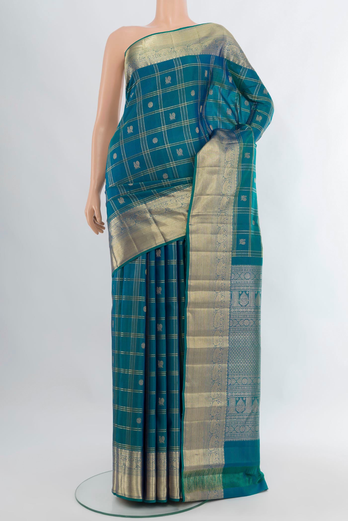 Peacock Blue Kanchipuram Silk Saree with Checked design on the body and Zari Border.  displayed on a mannequin