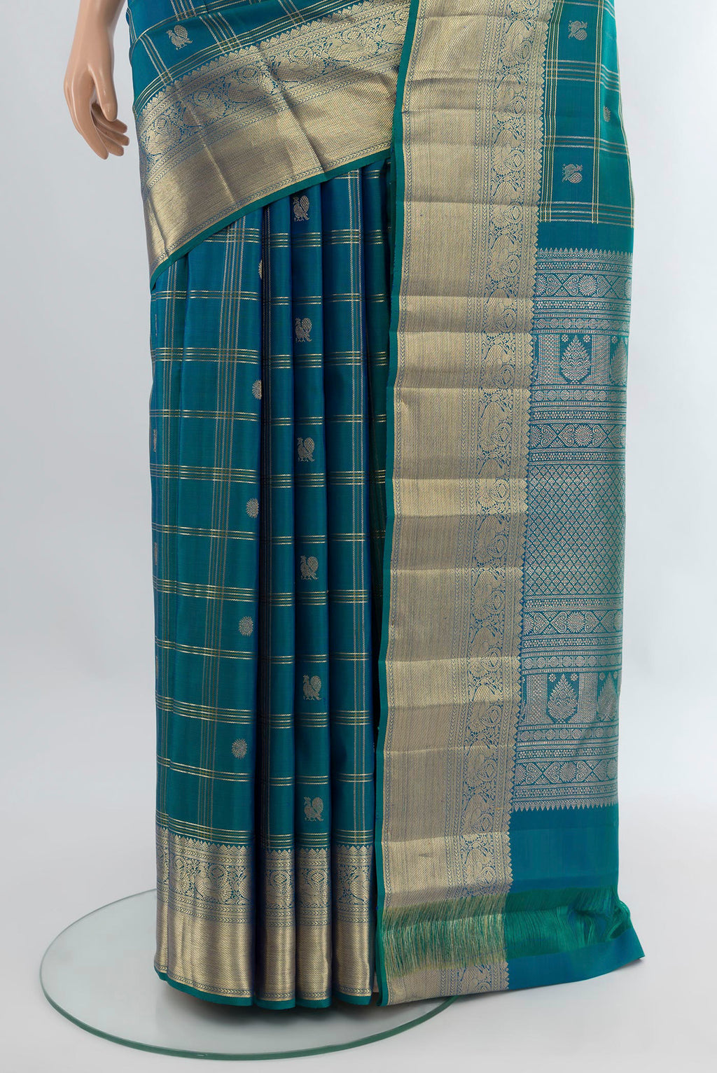 Pleats and pallu of Peacock Blue Kanchipuram Silk Saree with Checked design on the body and Zari Border. 