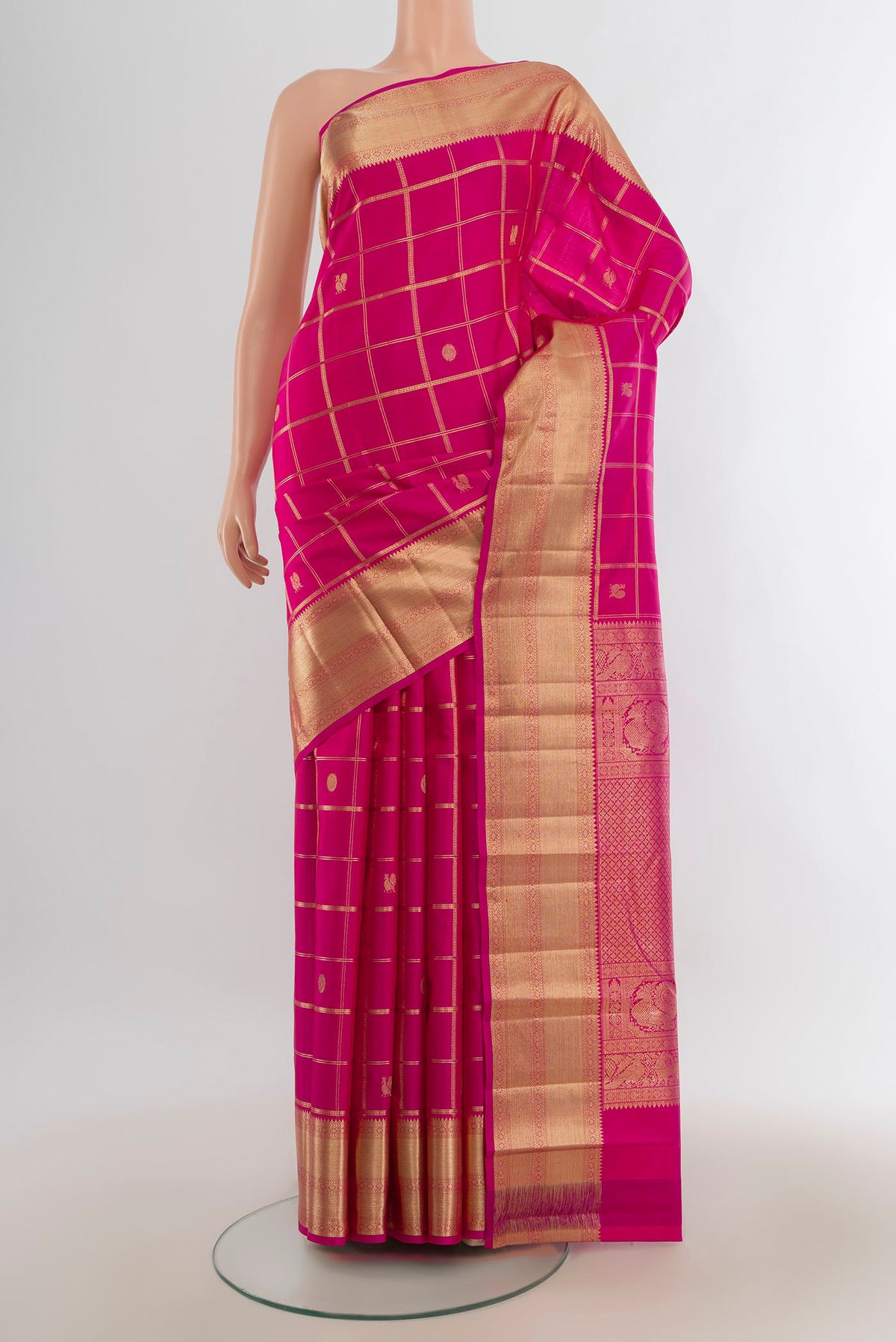 Pure Silk Rani Pink Kanchipuram Saree with Zari Butta on the body and Silk Border.  displayed on a mannequin