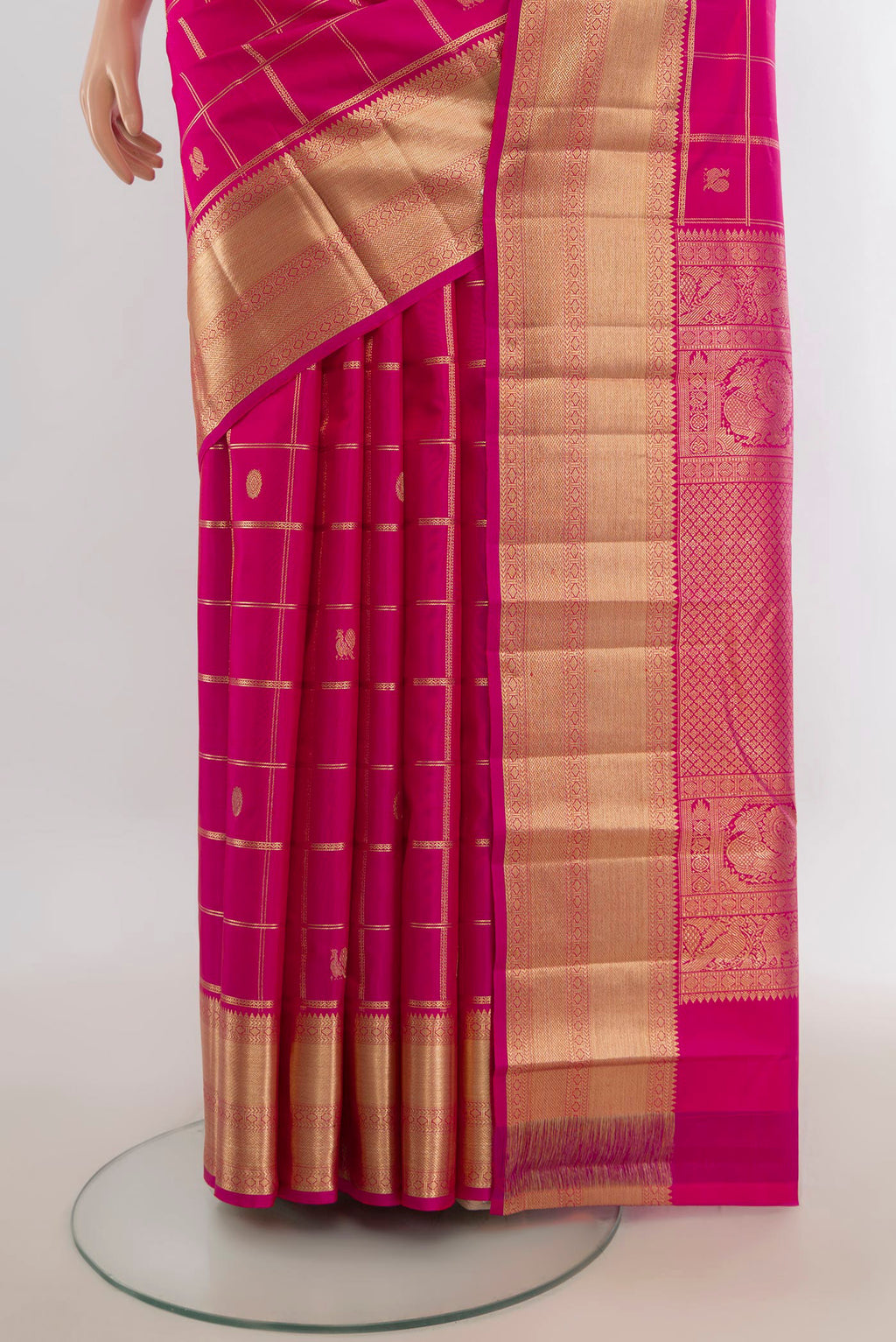 Pleats and pallu of Pure Silk Rani Pink Kanchipuram Saree with Zari Butta on the body and Silk Border. 
