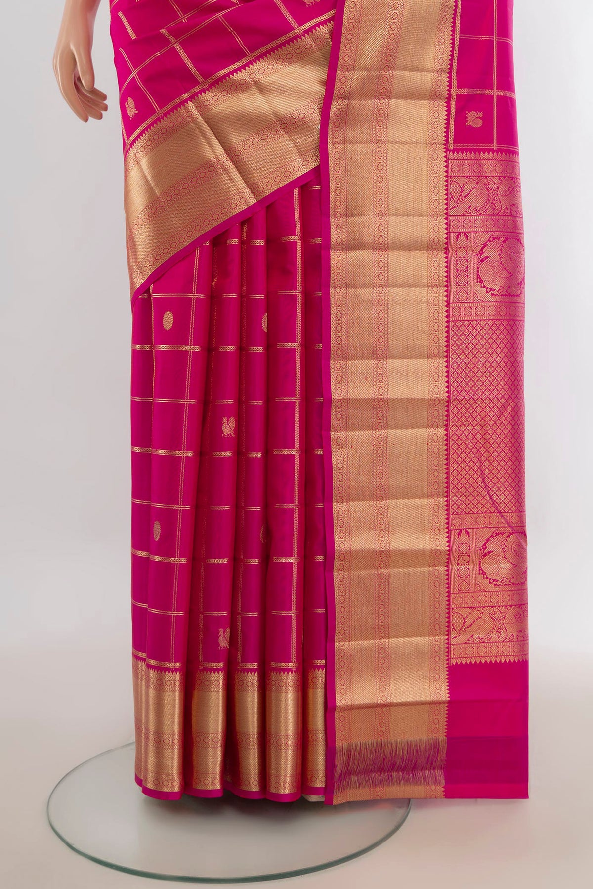 Pleats and pallu of Pure Silk Rani Pink Kanchipuram Saree with Zari Butta on the body and Silk Border. 