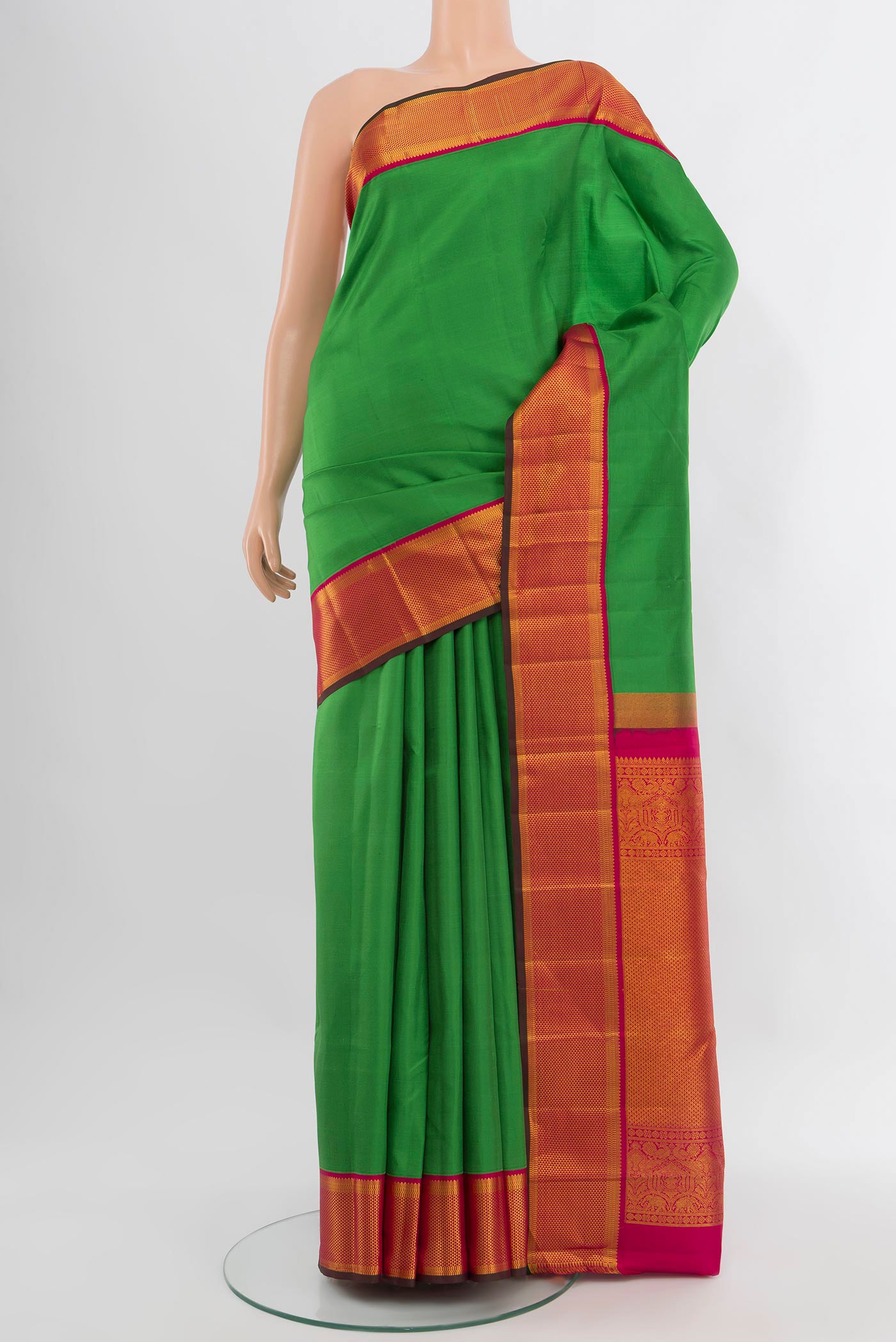 Green Kanchipuram Silk Saree with Plain Body and Zari Border.  displayed on a mannequin