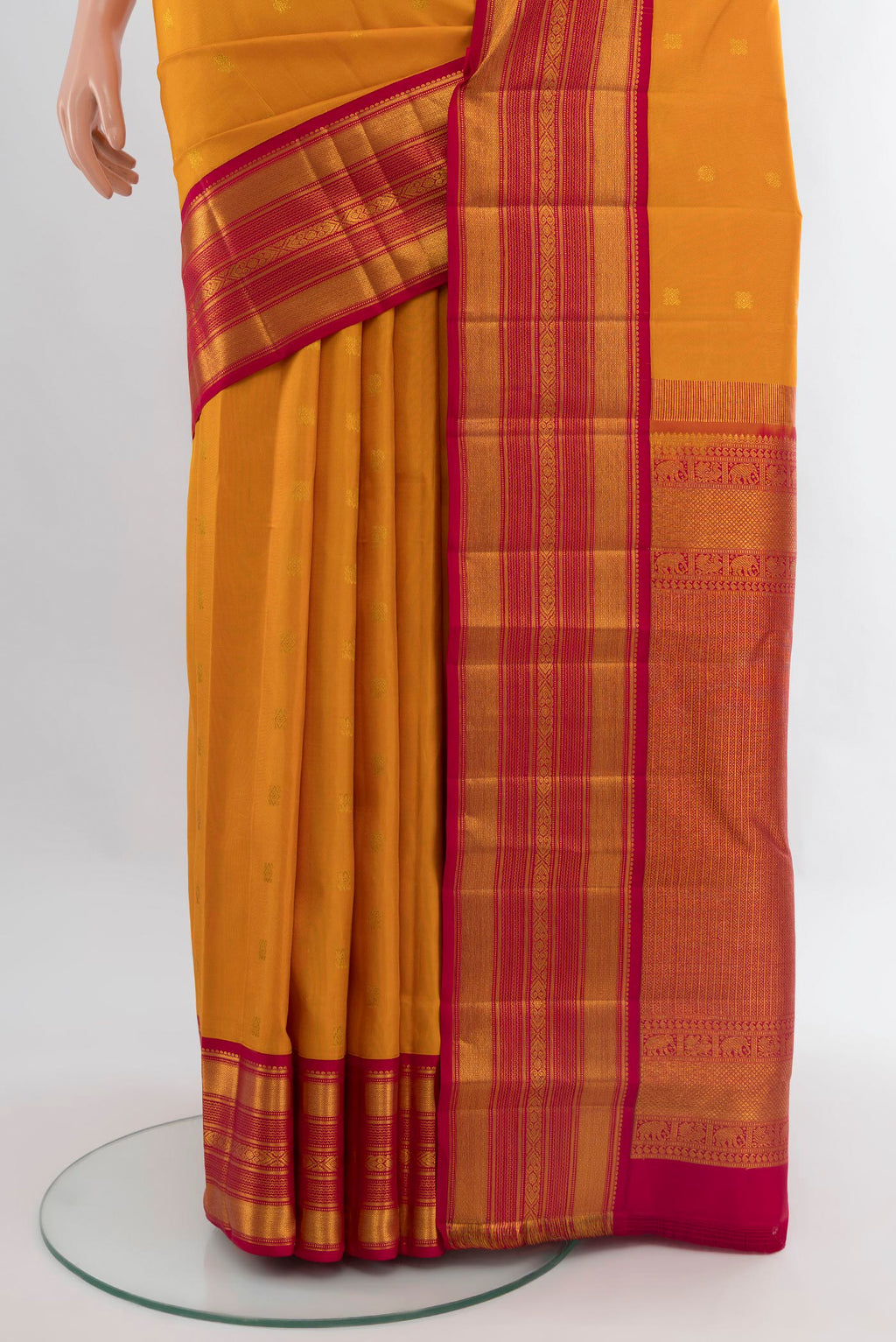 Pleats and pallu of Mustard Kanjivaram Silk Saree with Zari Butta on the body and Zari Border. 
