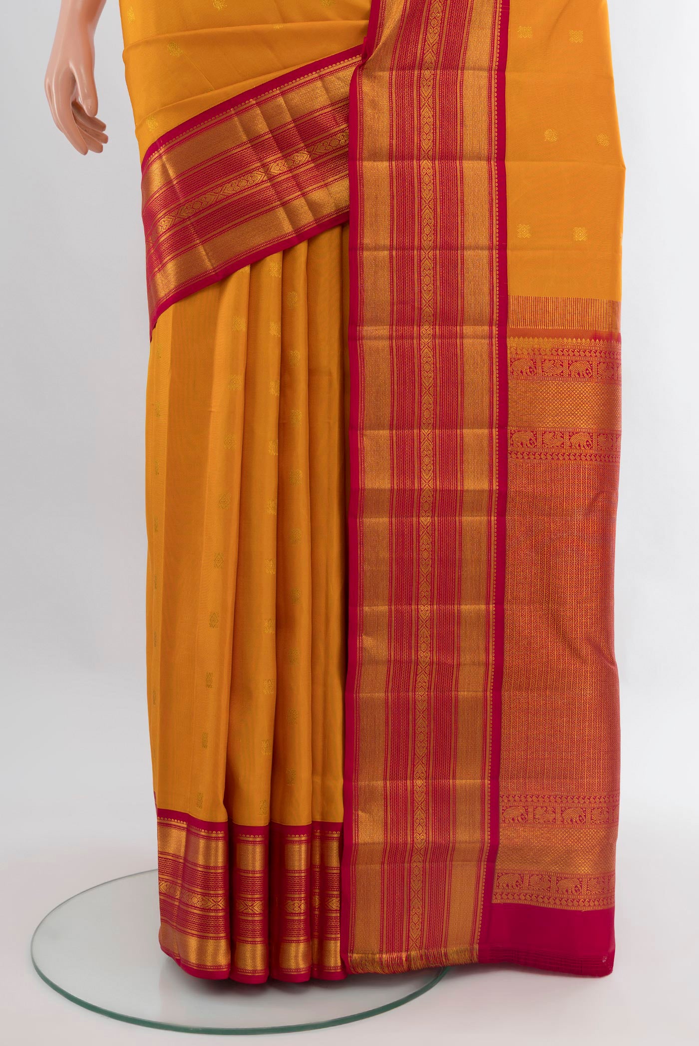 Pleats and pallu of Mustard Kanjivaram Silk Saree with Zari Butta on the body and Zari Border. 