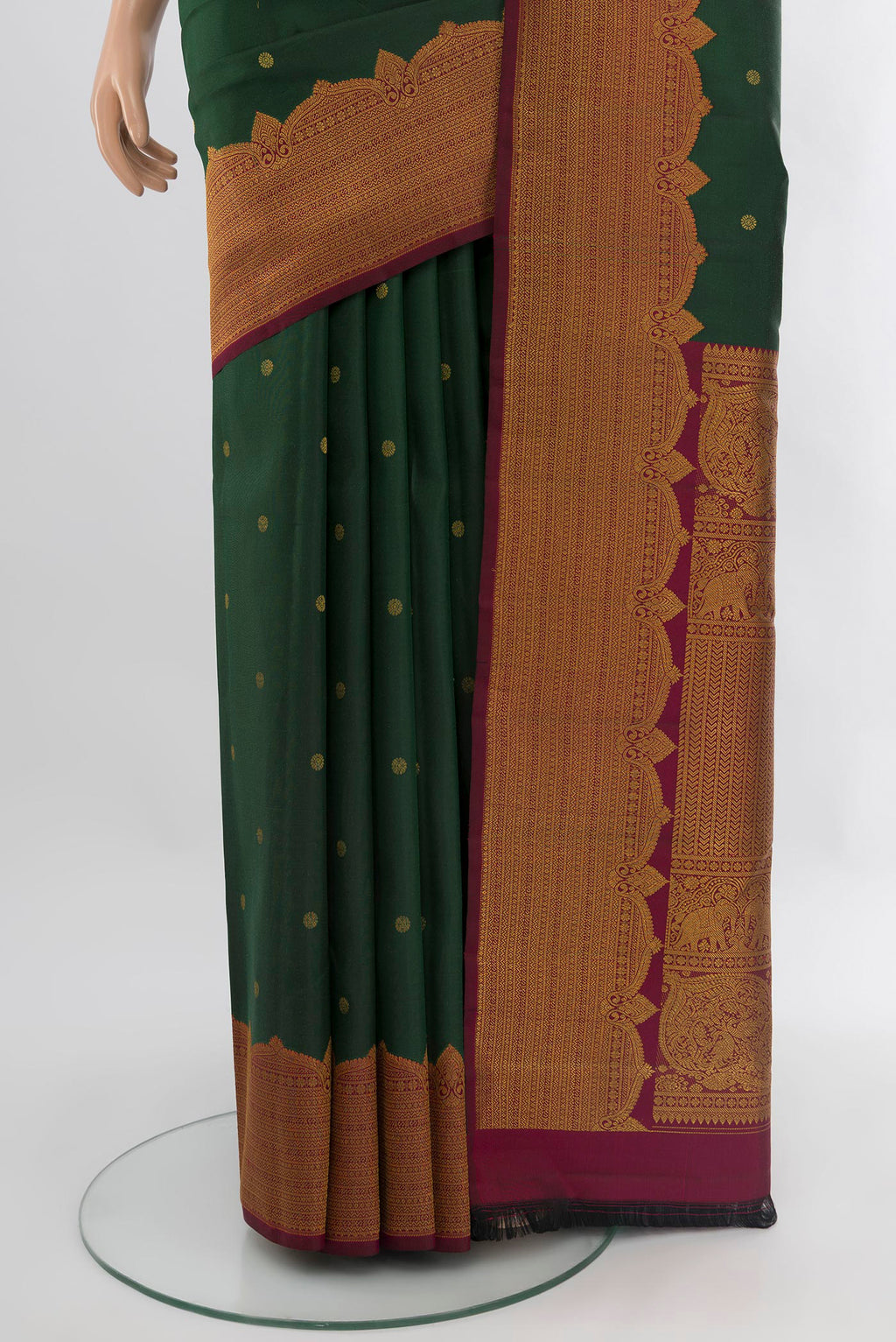 Pleats and pallu of Bottle Green Kanjivaram Silk Saree with Zari Butta on the body and Fancy Border. 