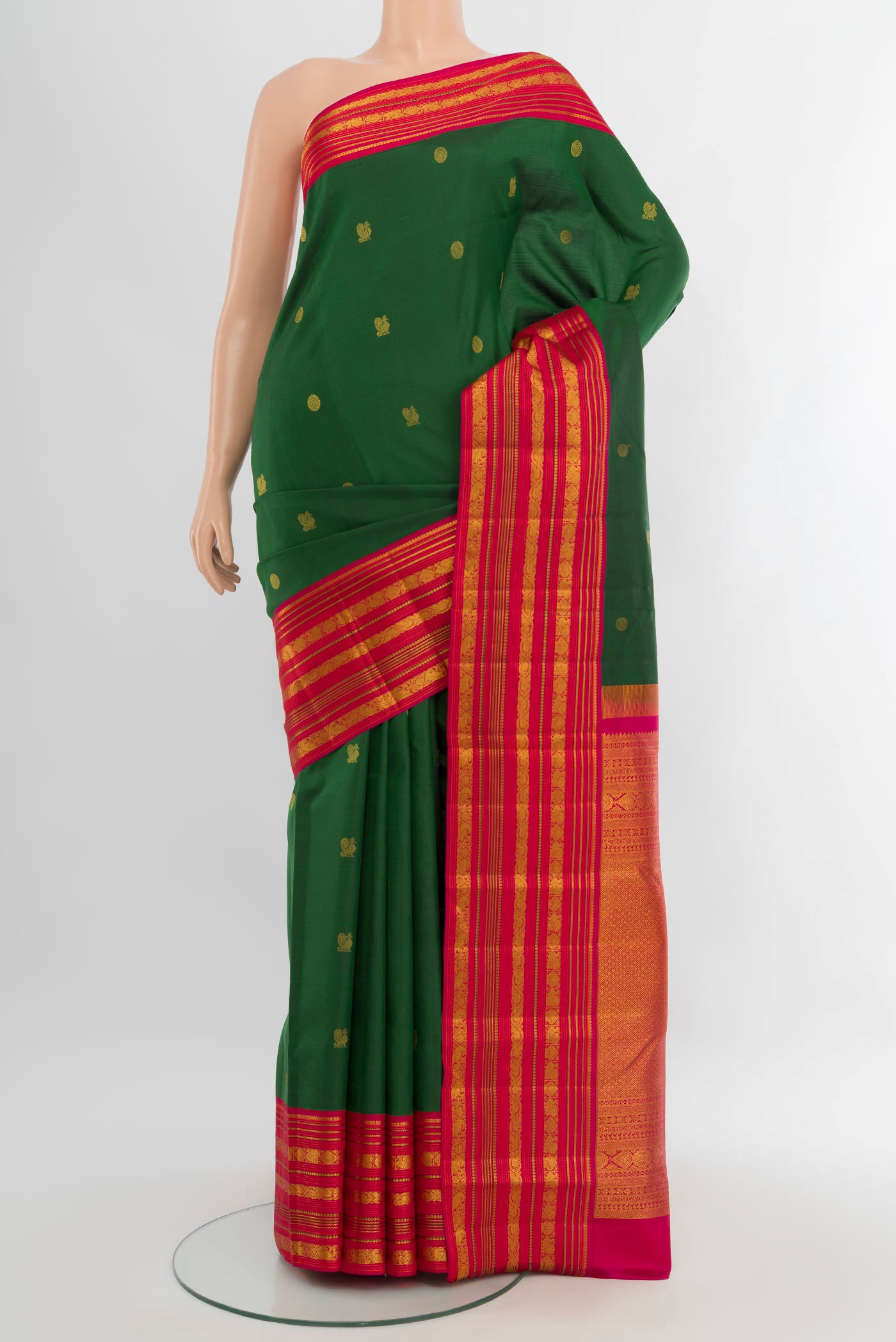Bottle Green Kanjivaram Silk Saree with Zari Butta on the body and Zari Border.  displayed on a mannequin