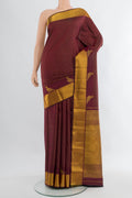 Maroon Kanchipuram Silk Saree with Checked design on the body and Zari Border.  displayed on a mannequin