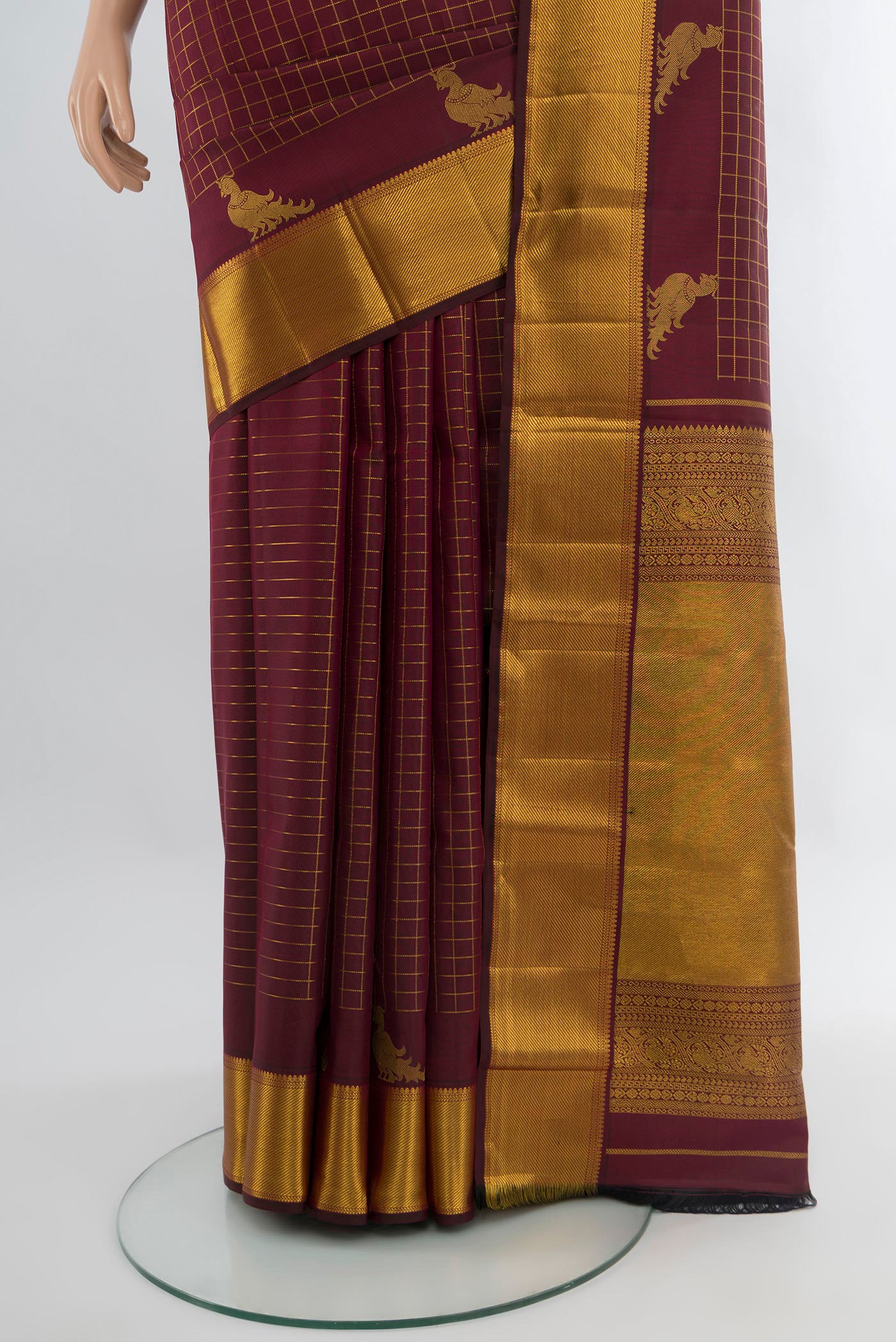 Pleats and pallu of Maroon Kanchipuram Silk Saree with Checked design on the body and Zari Border. 