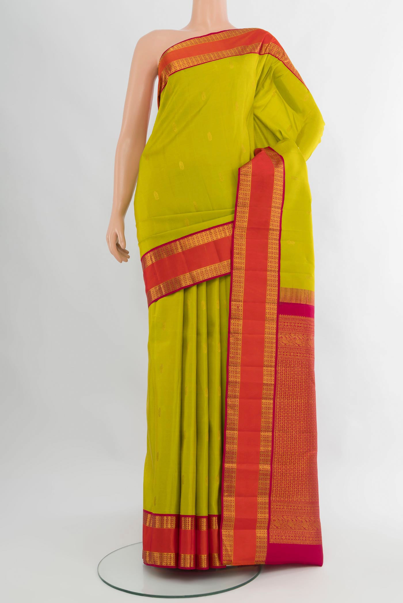 Light Green Kanchipuram Silk Saree with Zari Butta on the body and Zari Border.  displayed on a mannequin